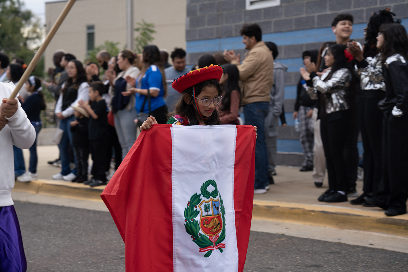 student-in-parade-holding-flag-of-Peru